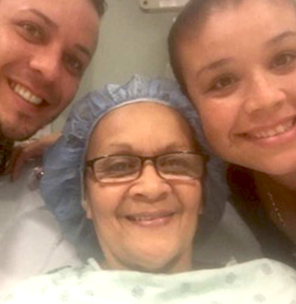 Selfie of Brian's mom, Marta in the hospital, smiling with Brian and sister 
