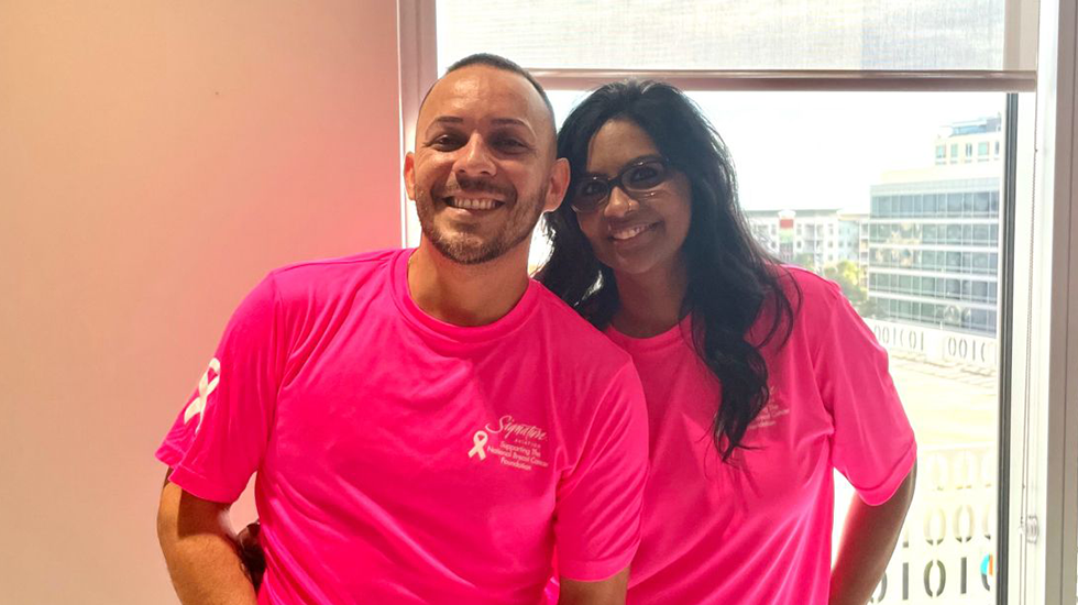 Briand and coworker at Signature Aviation Breast Cancer Awareness Day event