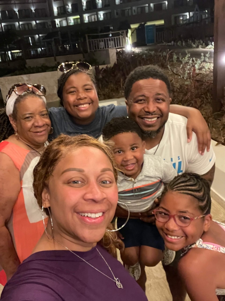 Tamara, Chris, and Teague taking a selfie with other family members