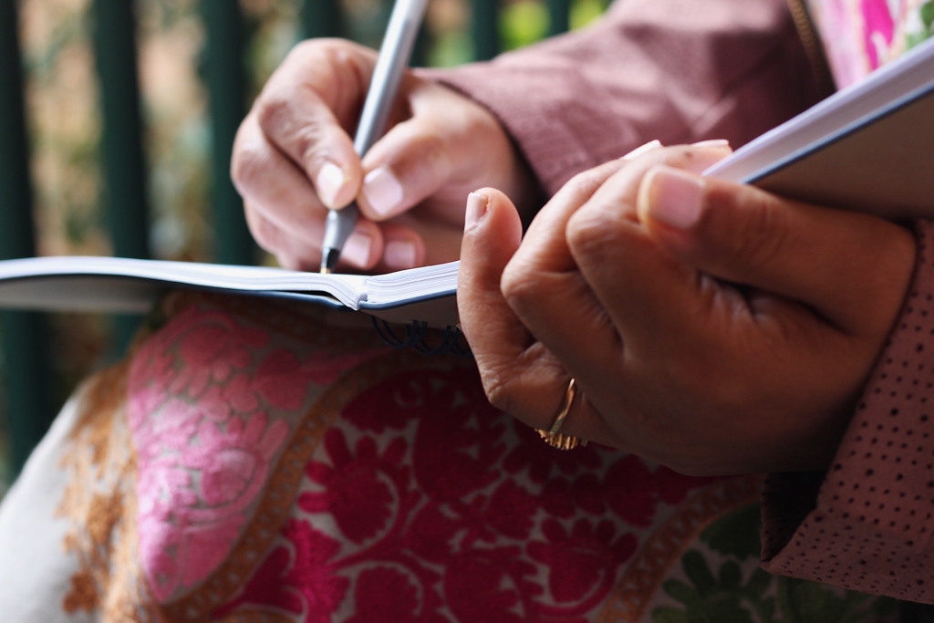 Woman writing in a journal