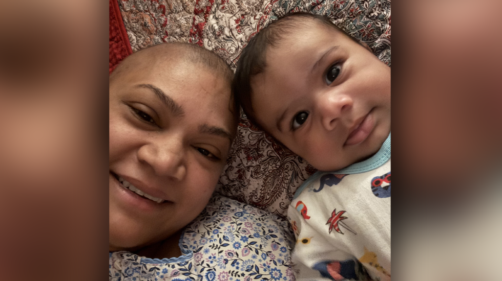 Photo of Anuradha and her baby, both with nearly bald head