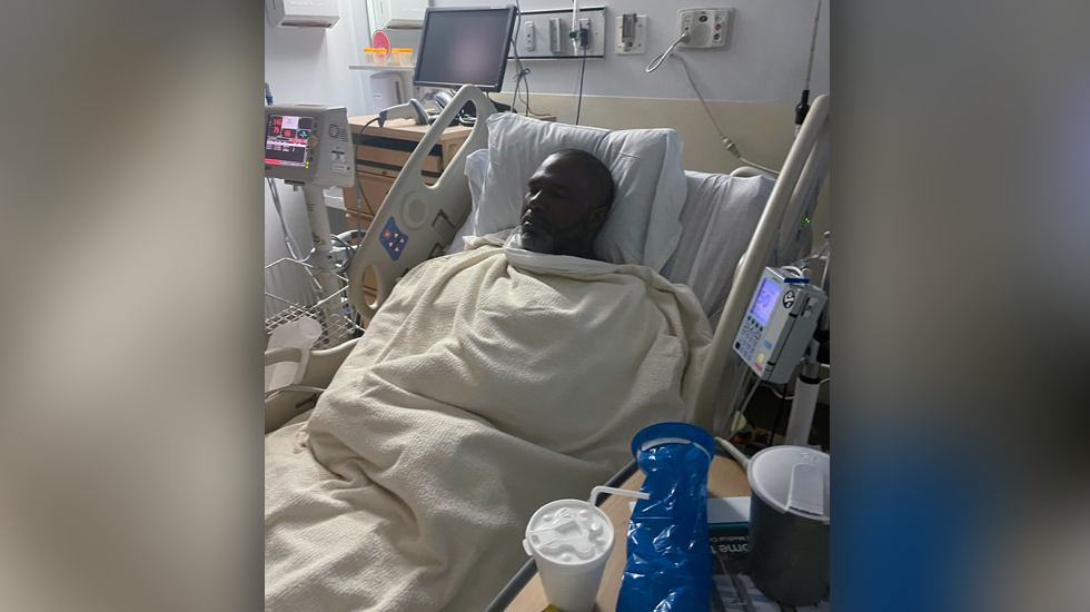 Photo of Jonathan in a hospital bed after his mastectomy surgery