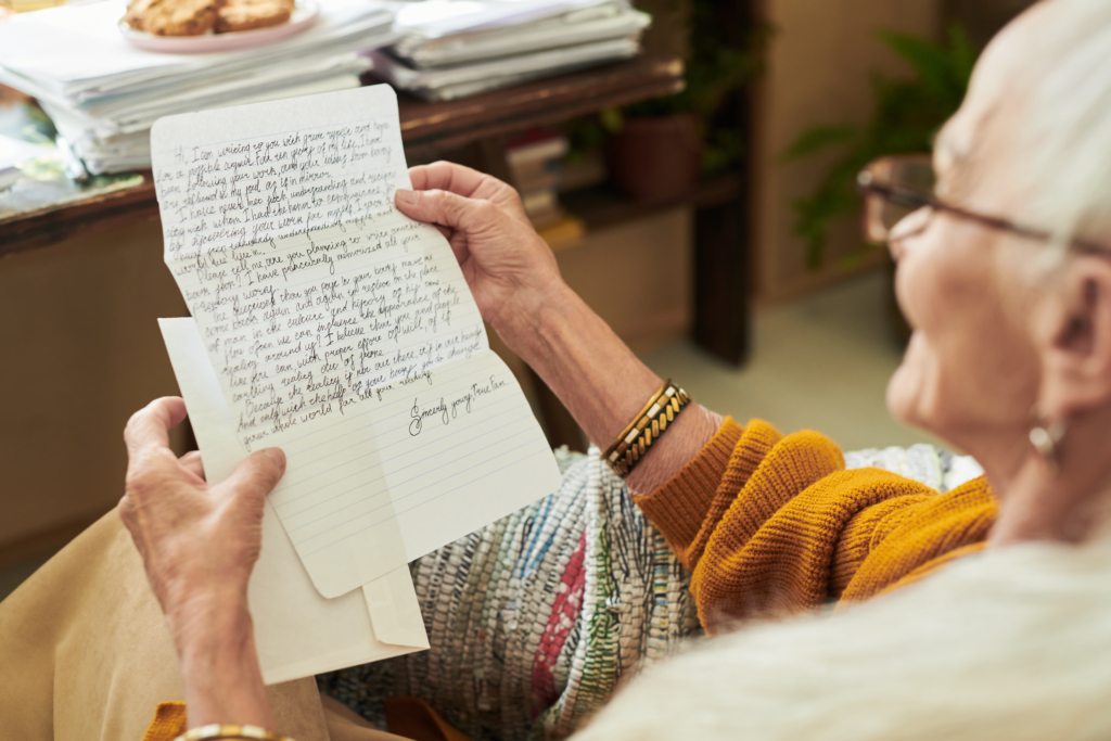 Picture of a woman reading a handwritten letter