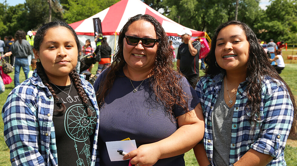 Family of three women in a fair or festival, showing mother and two daughters