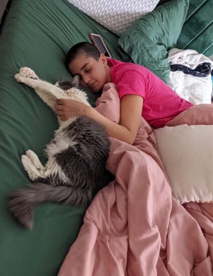 Michelle in bed with her cat 
