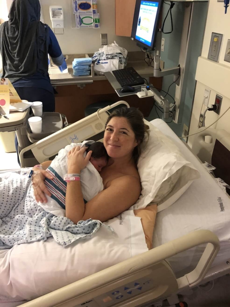 Sarah with her newborn baby girl at hospital bed