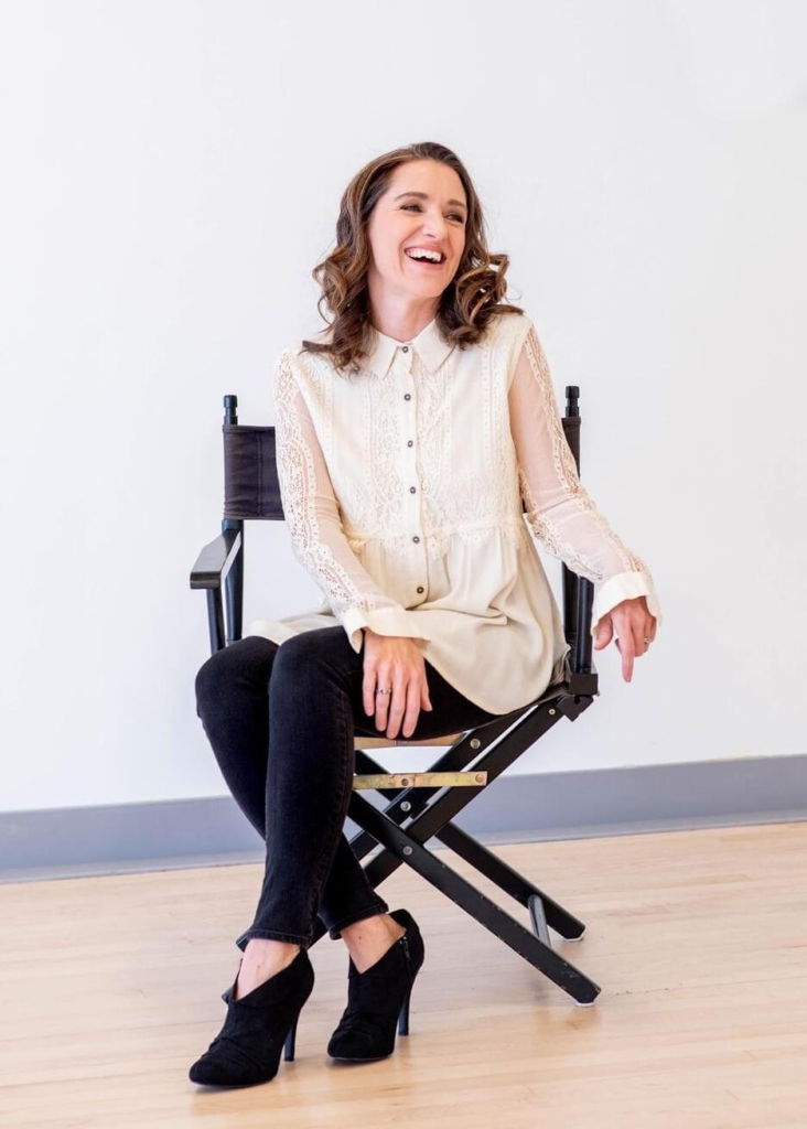 Stephanie in a studio chair smiling