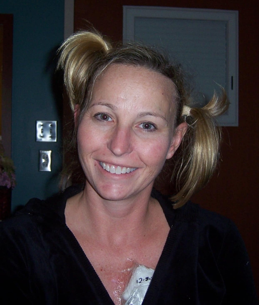 Tracy smiling with two ponytails