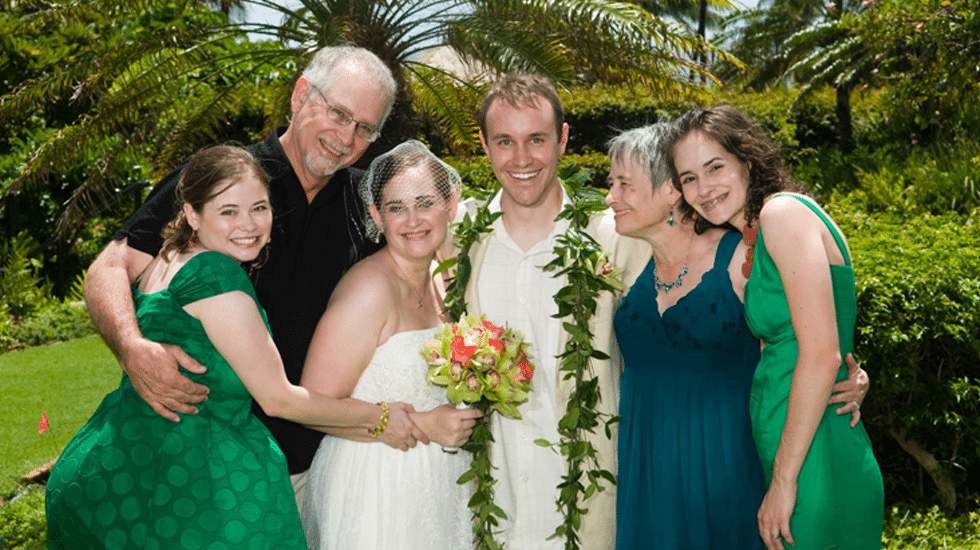 Becca Epperley at her wedding with her family and her mom