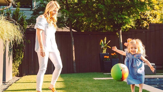 Jennifer and daughter Harper playing with a ball
